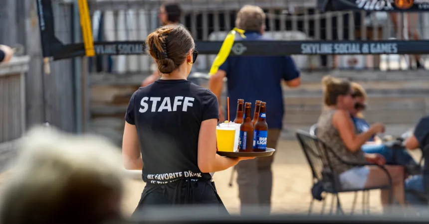 Skyline Team member delivering a drink outside